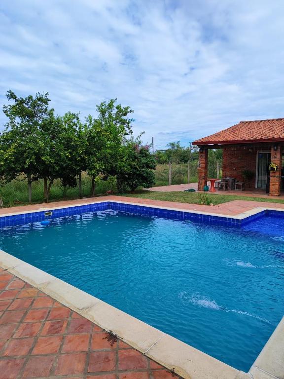 a swimming pool with blue water in a yard at Casita de Natalia in San Bernardino