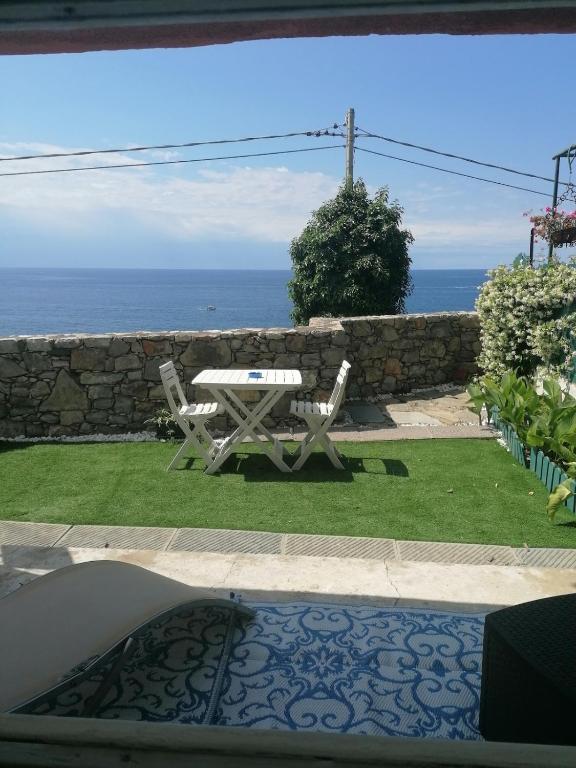 a patio with a table and chairs and the ocean at la terrazza relax in Corniglia