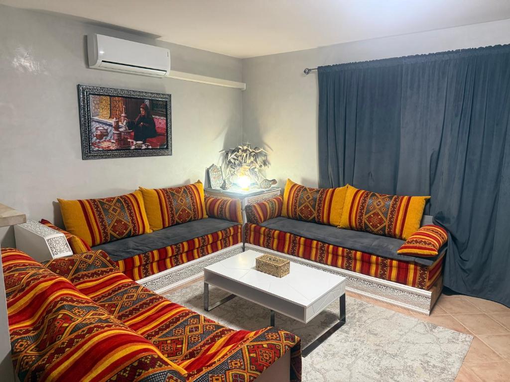 a living room with a couch and a table at Charmante maison au calme in Sainte-Maure