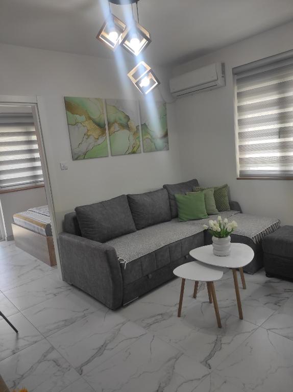 a living room with a couch and a table at SokoSTAR Apartman in Soko Banja