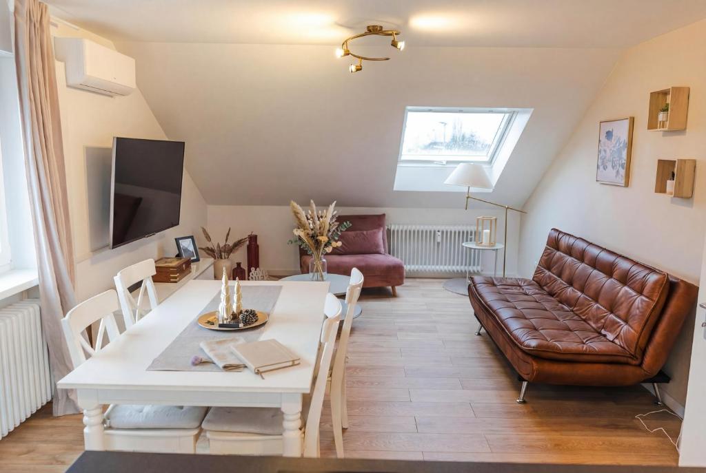 a living room with a couch and a table at Dreiländer Blick Apartments in Lörrach