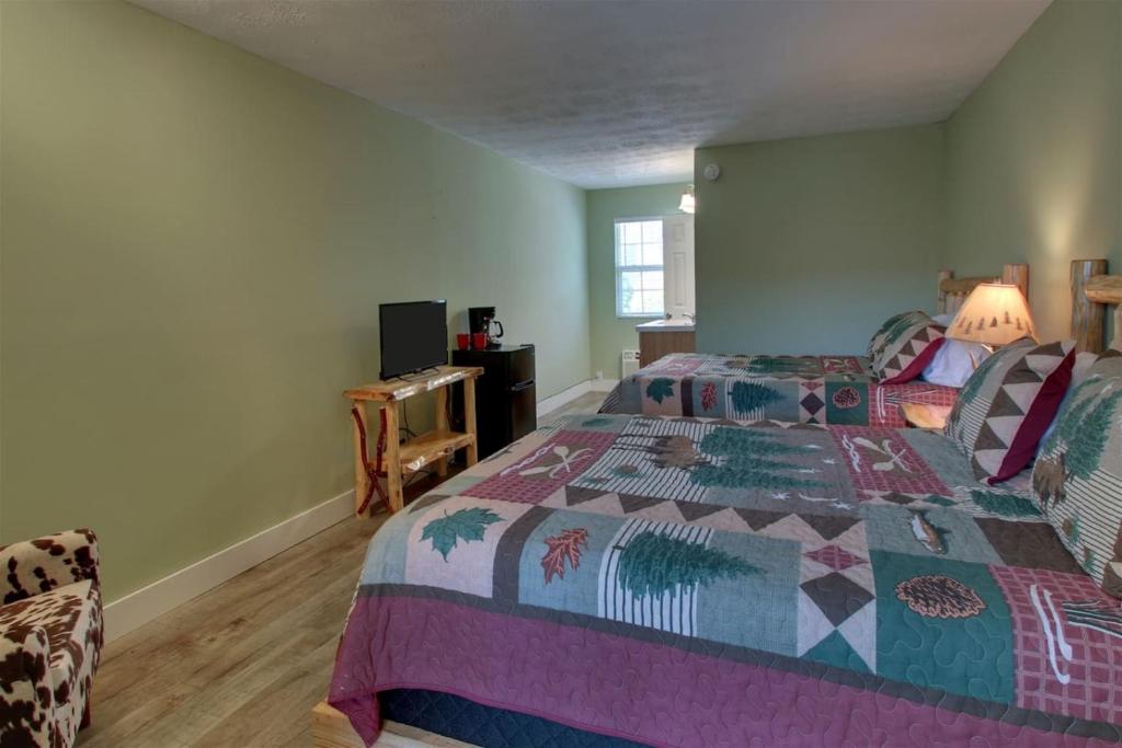 a bedroom with a large bed with a colorful quilt at Bavarian Brook 7A in Helen