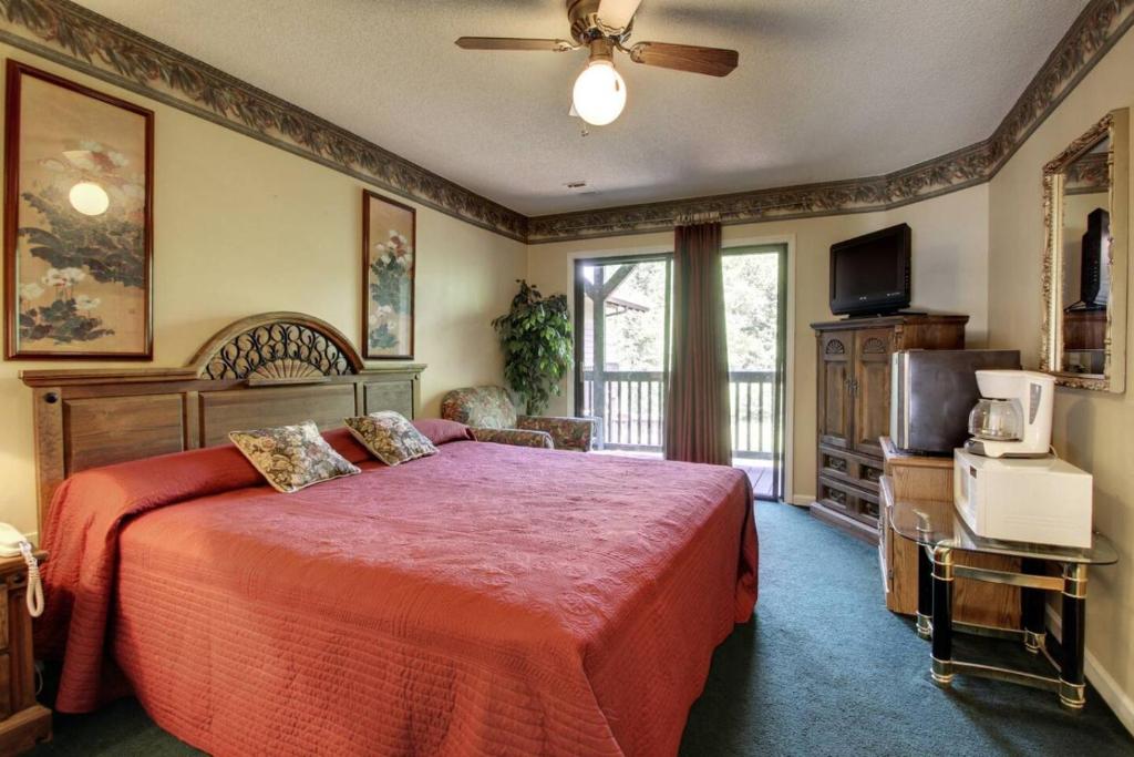 a bedroom with a bed and a ceiling fan at Rivers Edge 802b in Helen