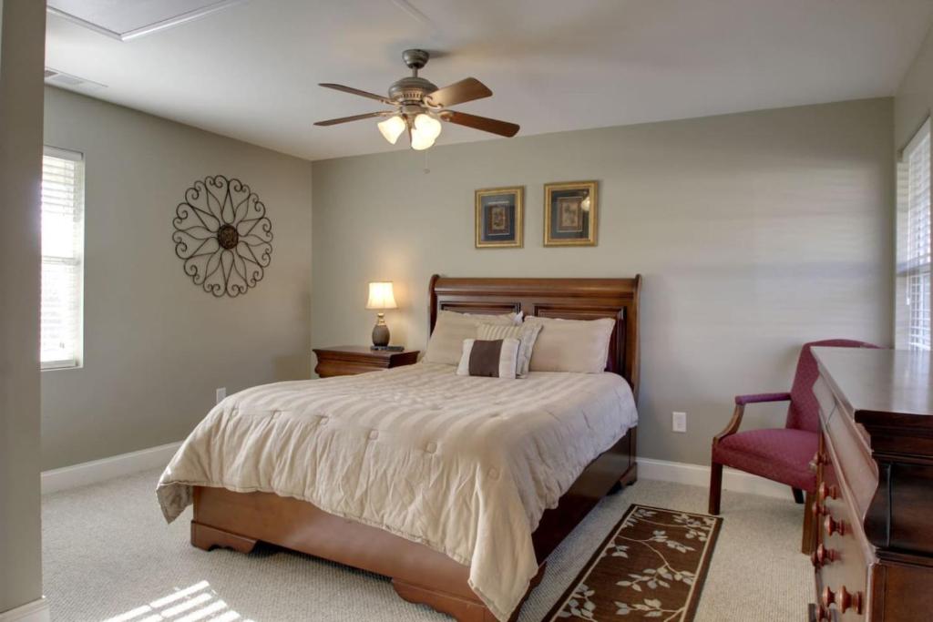 a bedroom with a bed and a ceiling fan at Bavarian Brook Condo 16 in Helen