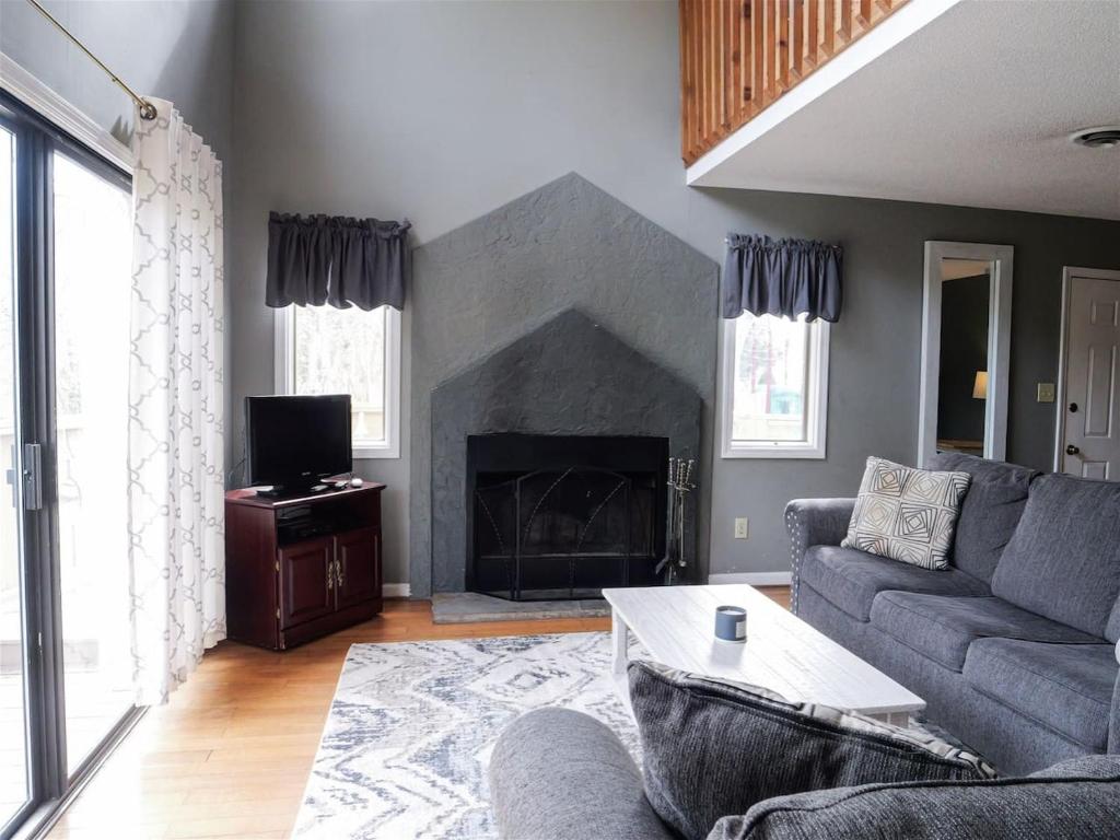 a living room with a couch and a fireplace at Rivers Edge Condo 101 in Helen