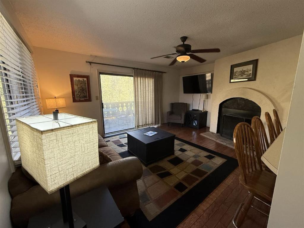 a living room with a couch and a fireplace at Rivers Edge 504 in Helen