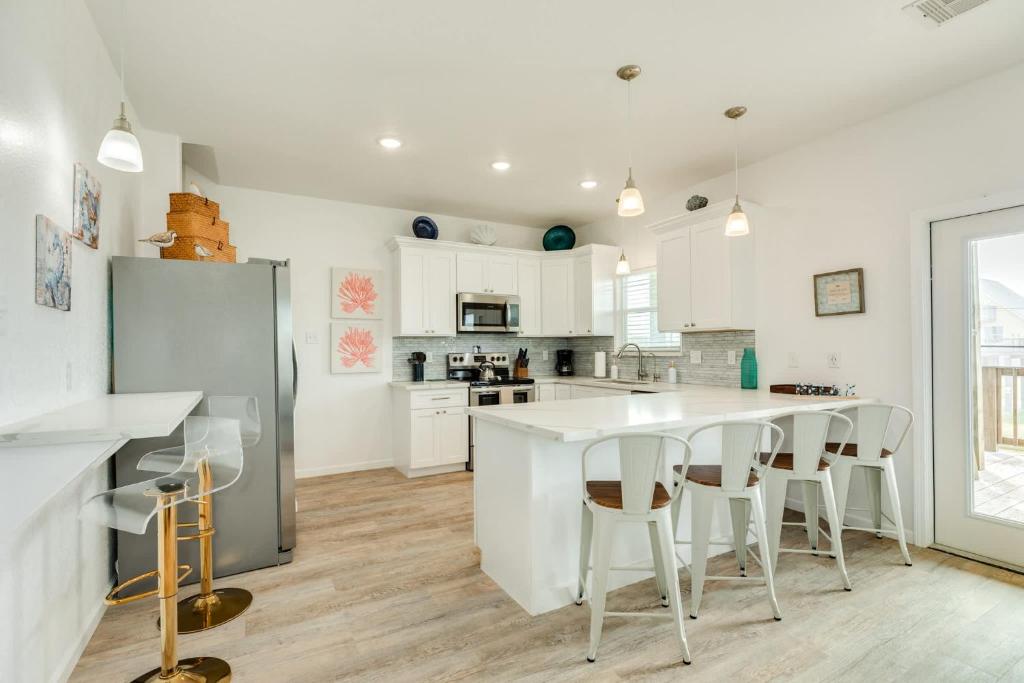 a kitchen with white cabinets and a kitchen island with chairs at Minutes to the Sand Spacious beautiful relaxing in Surfside Beach