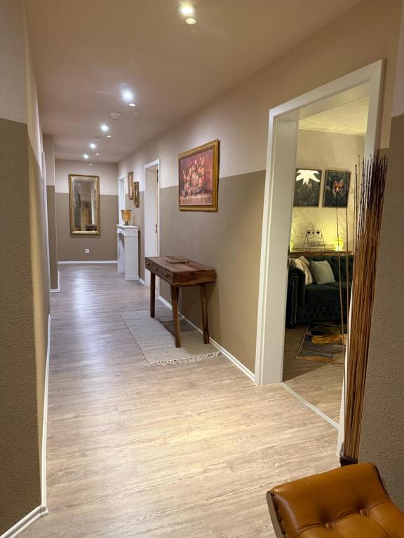 a room with a hallway with a table and a mirror at Haus der Geschichten in Marienberg