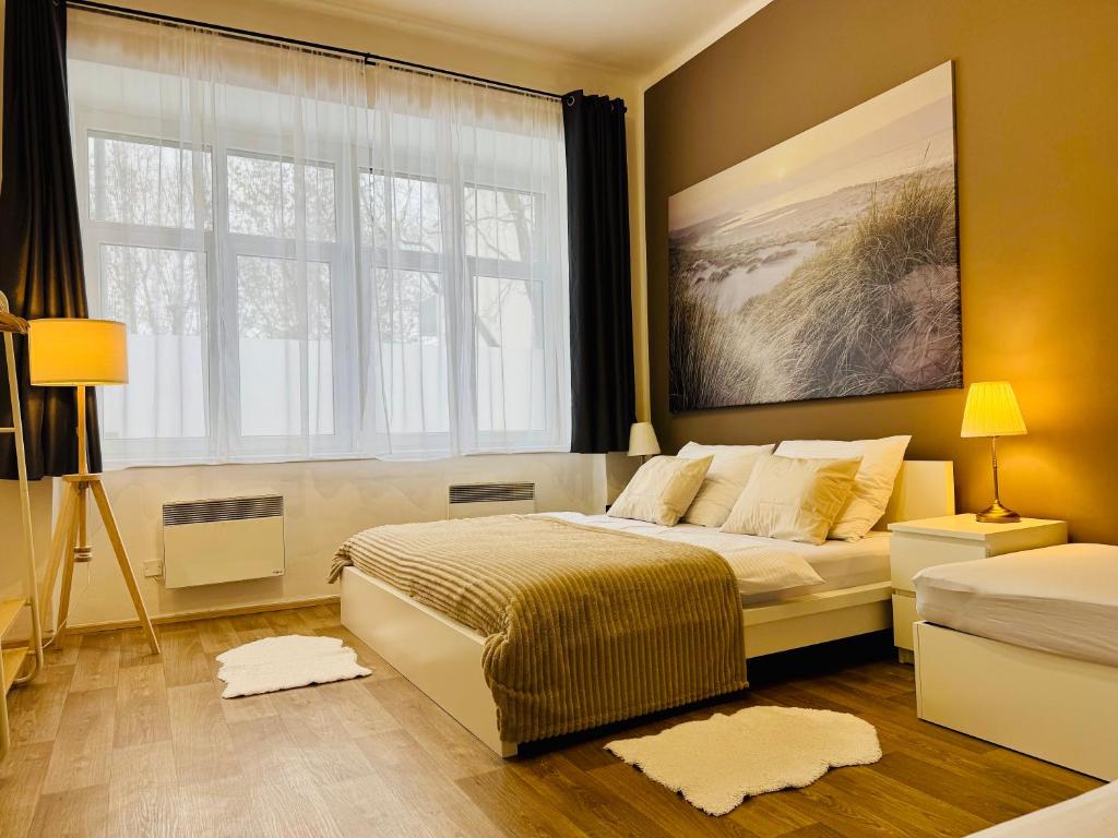 a bedroom with a bed and a large window at City Apartment 920 in Pardubice