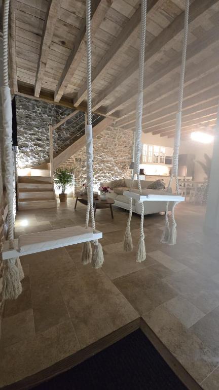 a room with two swinging beds in a building at Love room- Le Cocon Osé in Autun