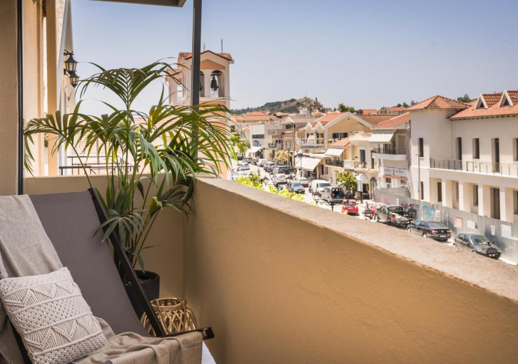 a balcony with a view of a city at Nomāde Agora Suites - Lixouri Town Centre, Kefalonia - Private Balconies in Lixouri