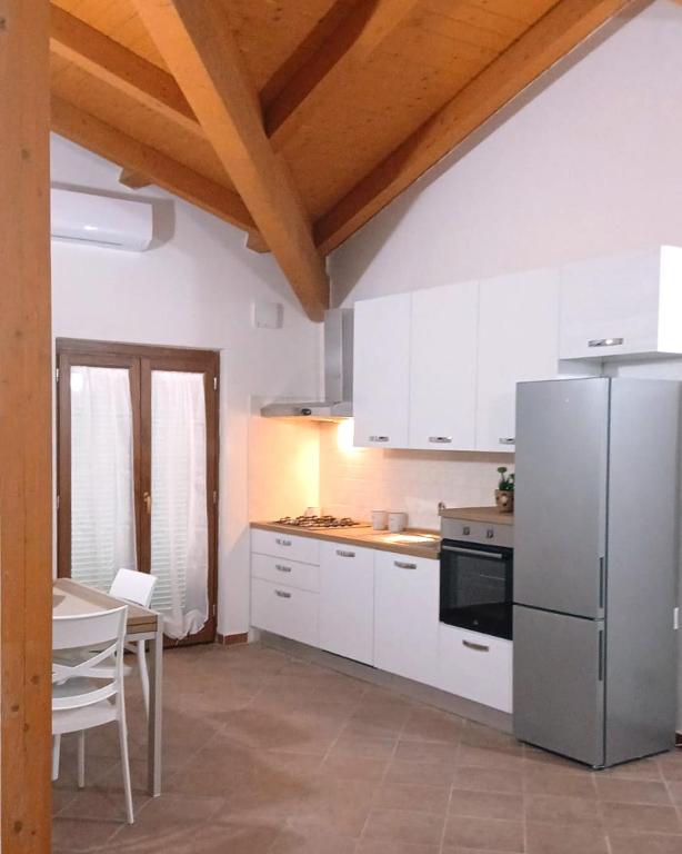 a kitchen with a stainless steel refrigerator and a table at Residence Il Casolare in Piedimonte San Germano