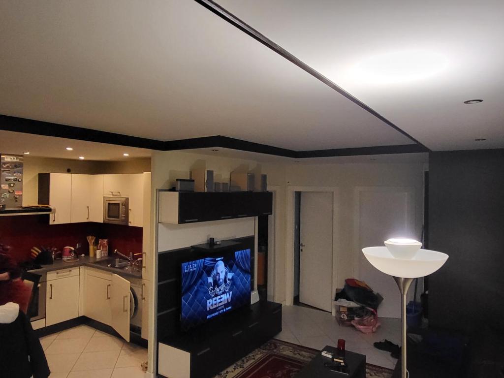 a living room with a flat screen tv on a ceiling at Snp 18 luxury in Košice