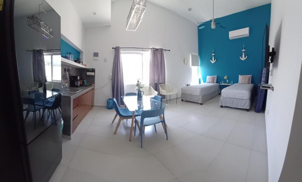 a kitchen and living room with a table and chairs at Nautica Apartment-4 guests and shared pool in Isla Mujeres
