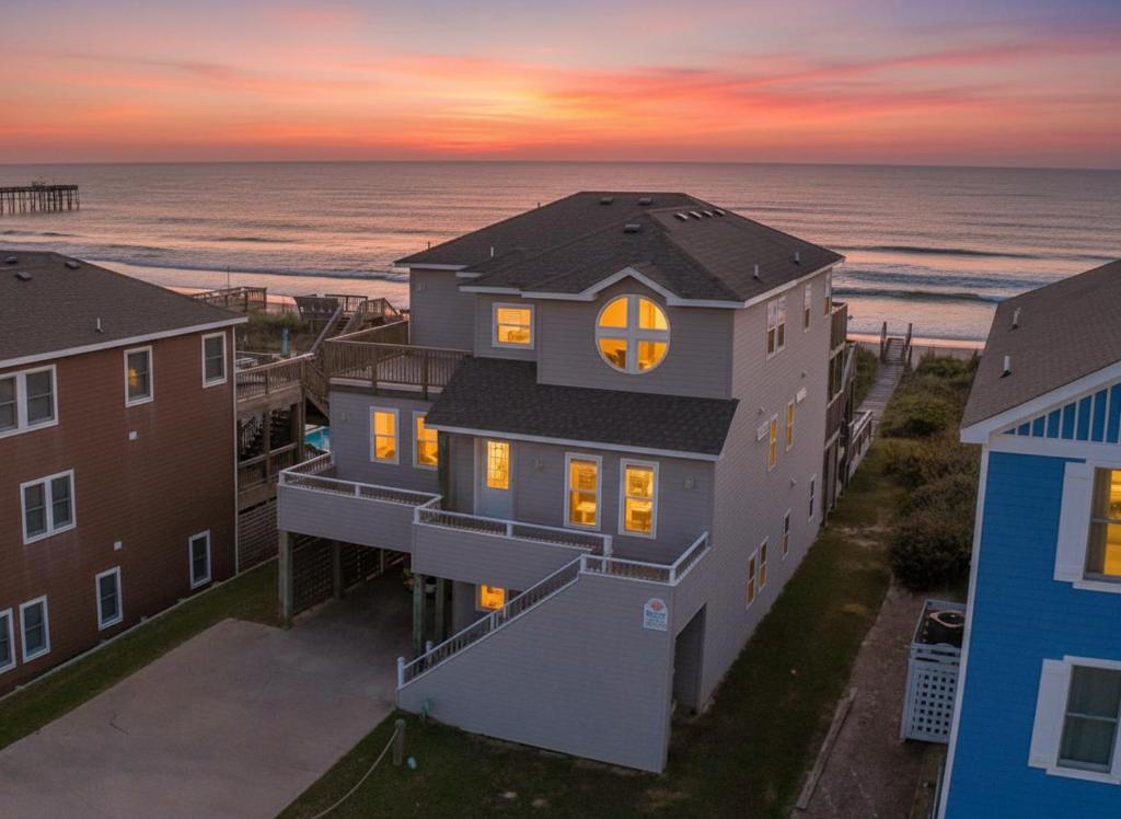 an aerial view of a house and the beach at Serenity in Nags Head - MP 11, Oceanfront, Ocean View, Pool, Hot Tub, Pets OK, YR Flex Stays in Nags Head