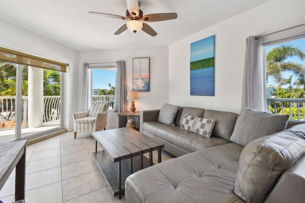 a living room with a couch and a table at Sunsets & Coastal Vibes Treasure Island Stay in St. Pete Beach