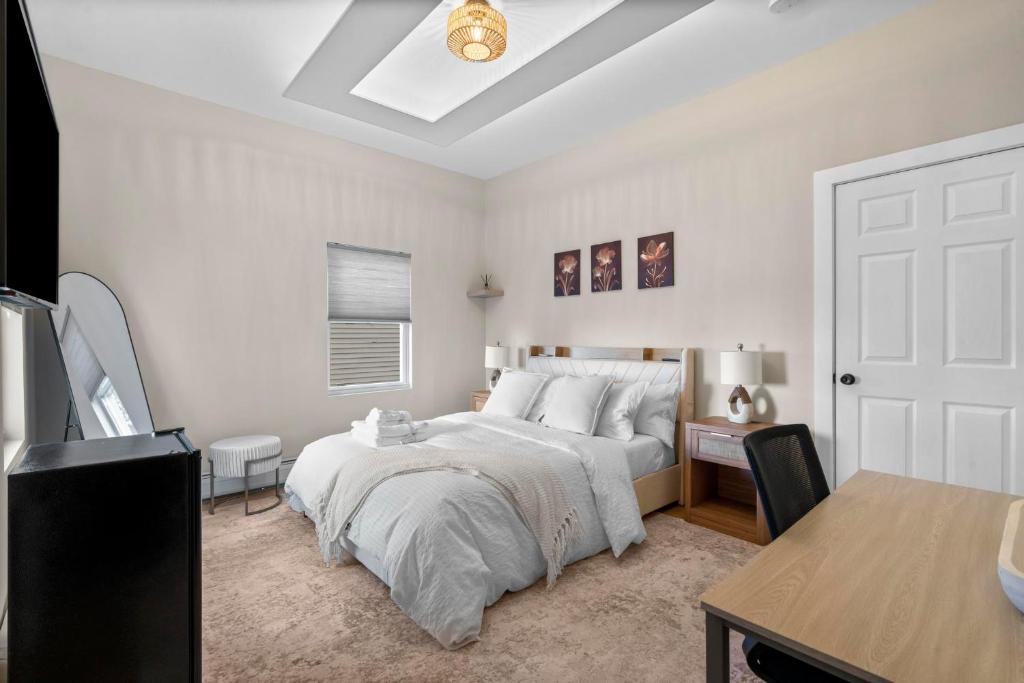 a bedroom with a bed and a desk and a table at Blatchley Rooms by Yale in New Haven