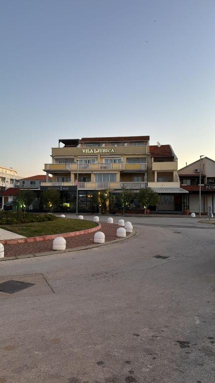 a large building with white balls in front of it at Villa Ljubica in Pakoštane