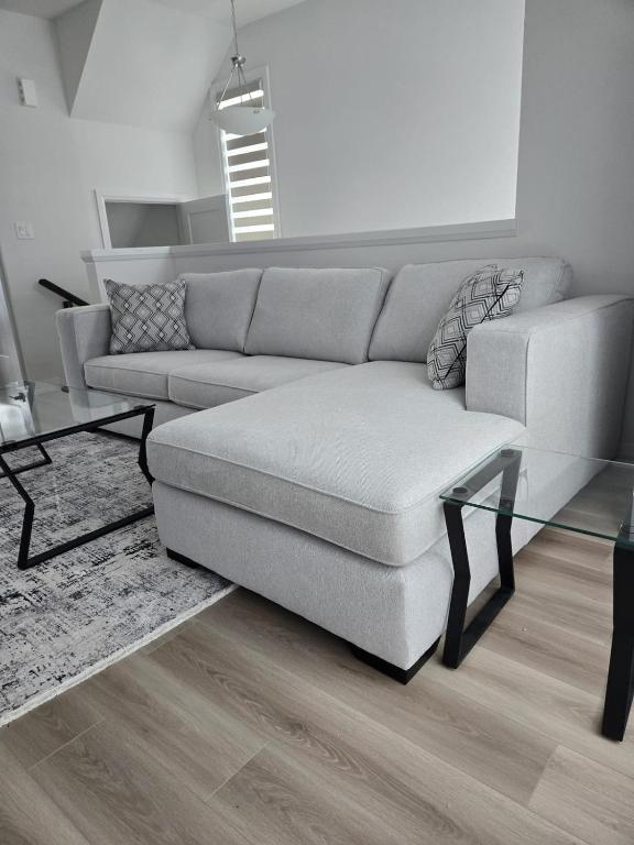 a living room with a couch and a glass table at Modern 3BR FriendlyTown Home in Paris