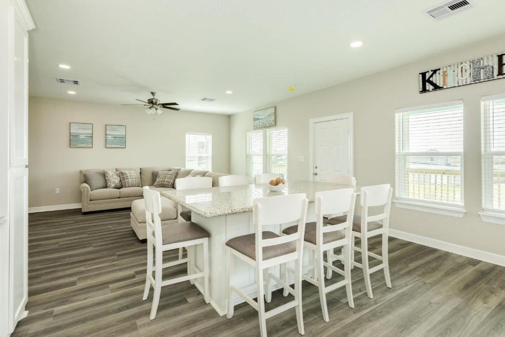 a kitchen and dining room with a white table and chairs at Minutes to Beach & Jetty Fishing Fun Get-a-way in Surfside Beach