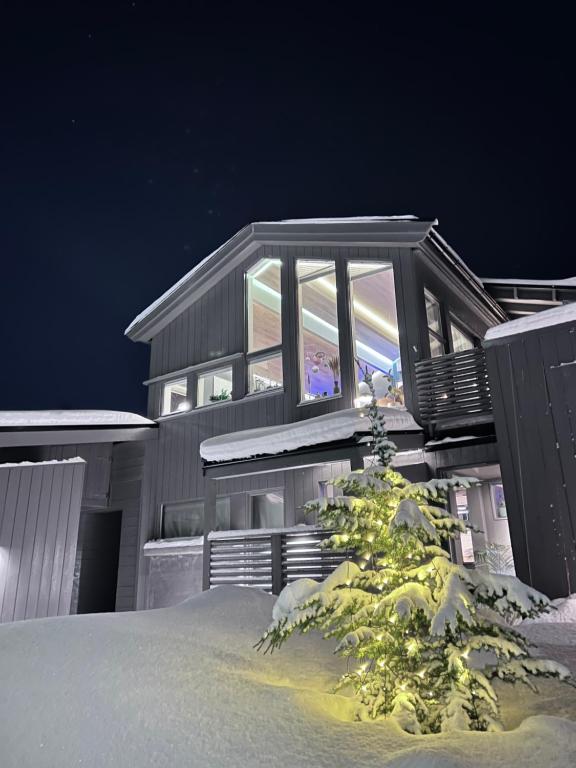 a house with a window on the side of it at Modern Luxplace with Northern Light view in Tromsø