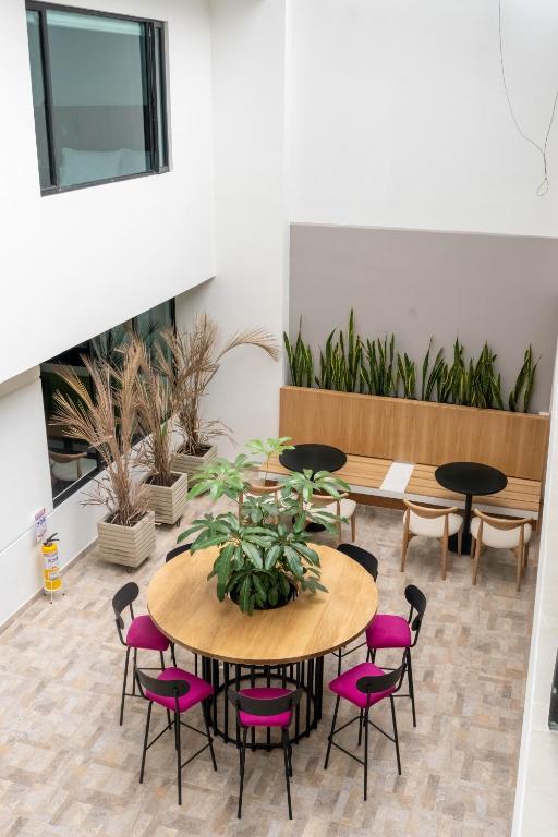 a room with a table and chairs and plants at Casa Siete Hotel Boutique in Bogotá