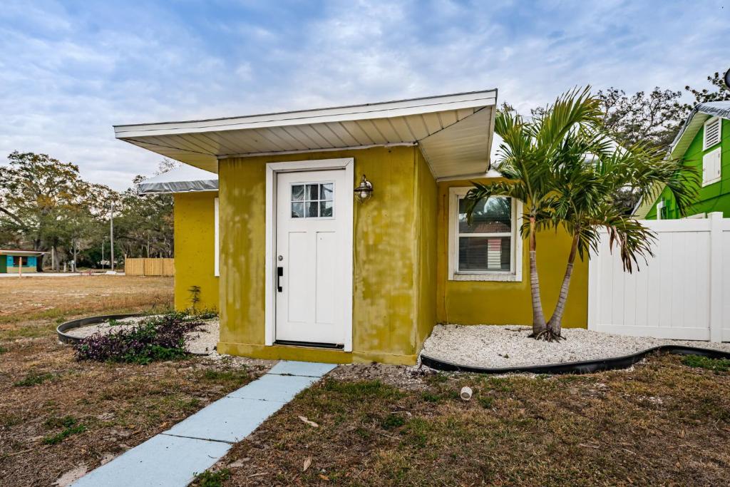 a small yellow house with a white door at Sunshine Tropical Villa in Largo
