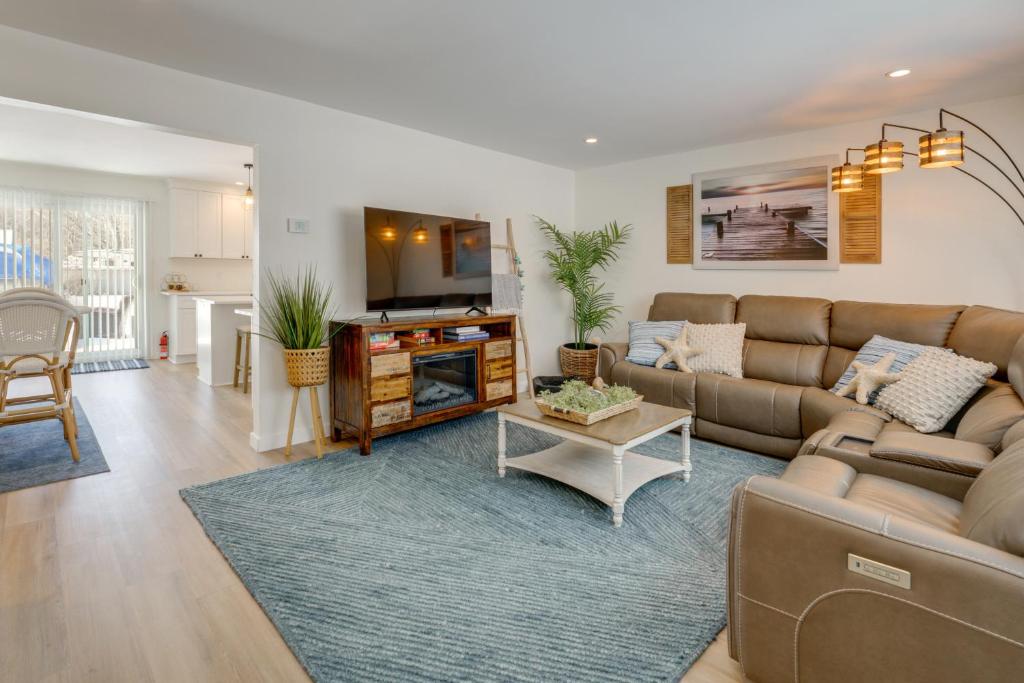 a living room with a couch and a tv at Deck, Fire Pit! Fully Updated Home Near Lake Huron in Caseville