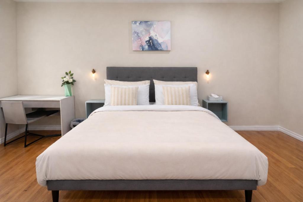 a bedroom with a large white bed and a desk at Vita House - Minutes to Rogers Stadium - Walk or Transit - Near VELD Downsview and Yorkdale in Toronto