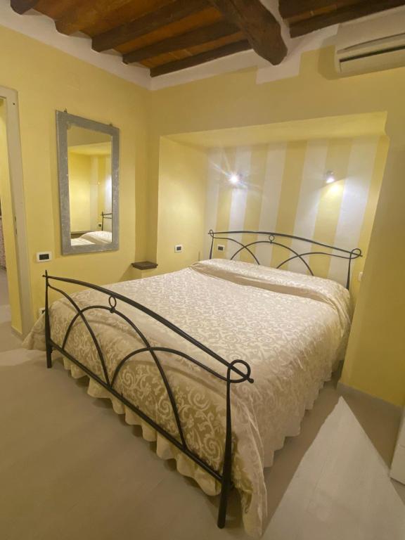 a bedroom with a bed with a metal frame at Gaia's Apartment in Pistoia