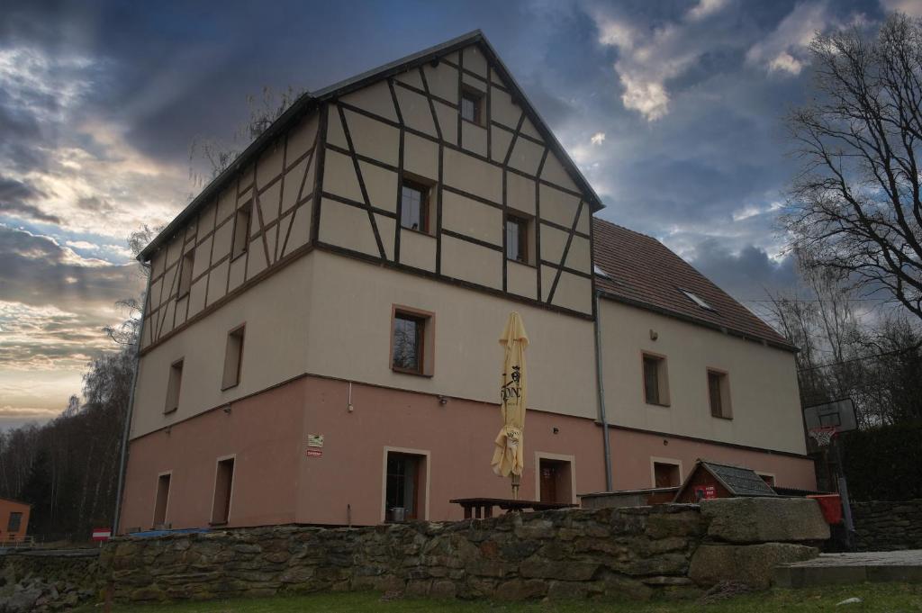 a large building with a flag on the side of it at Penzion Černý mlýn in Březová