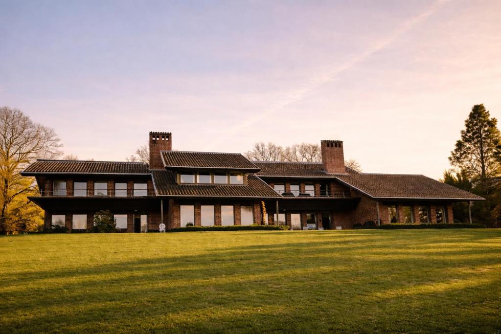 a large house with a grassy field in front of it at Sæbygaard Estate Kalundborg in Ruds-Vedby