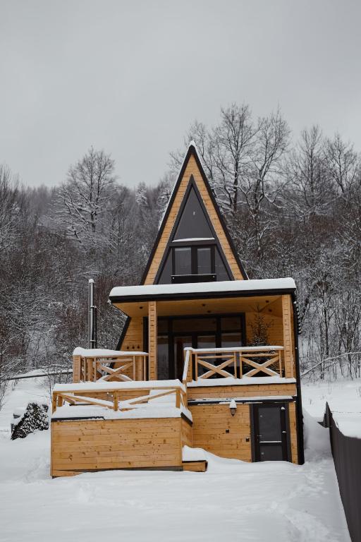 a log cabin in the snow with snow at Zelemin House in Skole