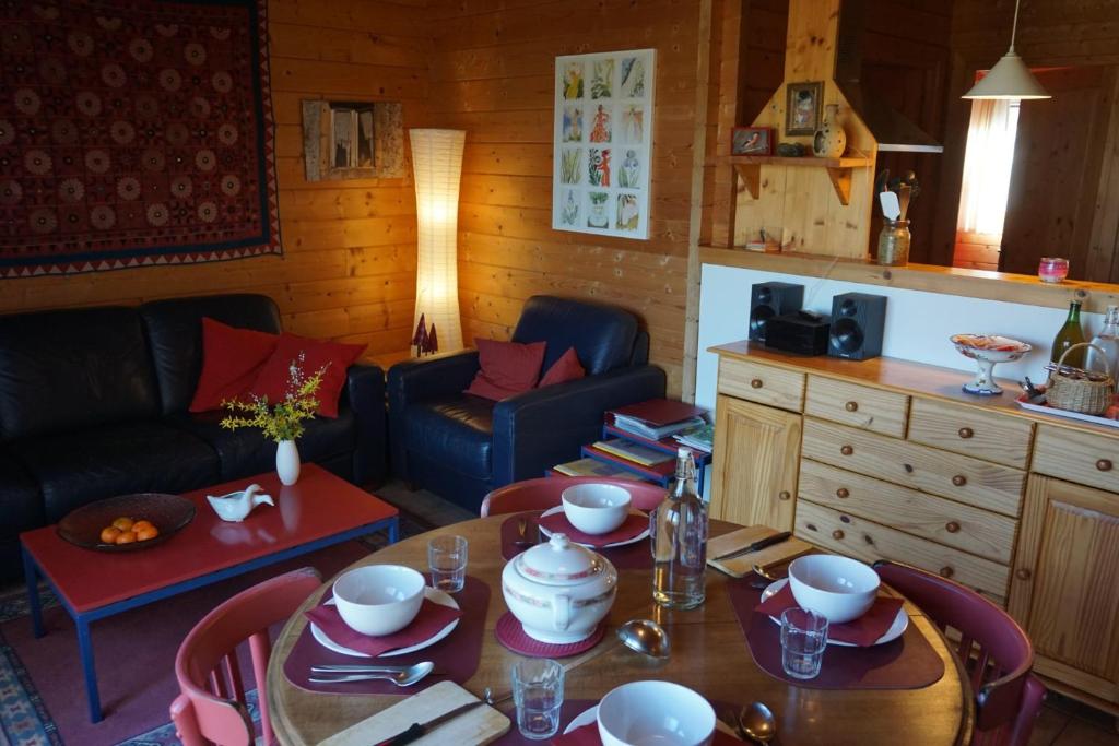 a living room with a table and a couch at La petite source in Florenville