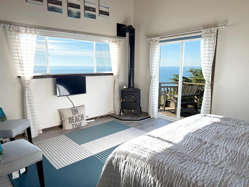 a bedroom with a bed and a view of the ocean at Bella Oceana in Dillon Beach