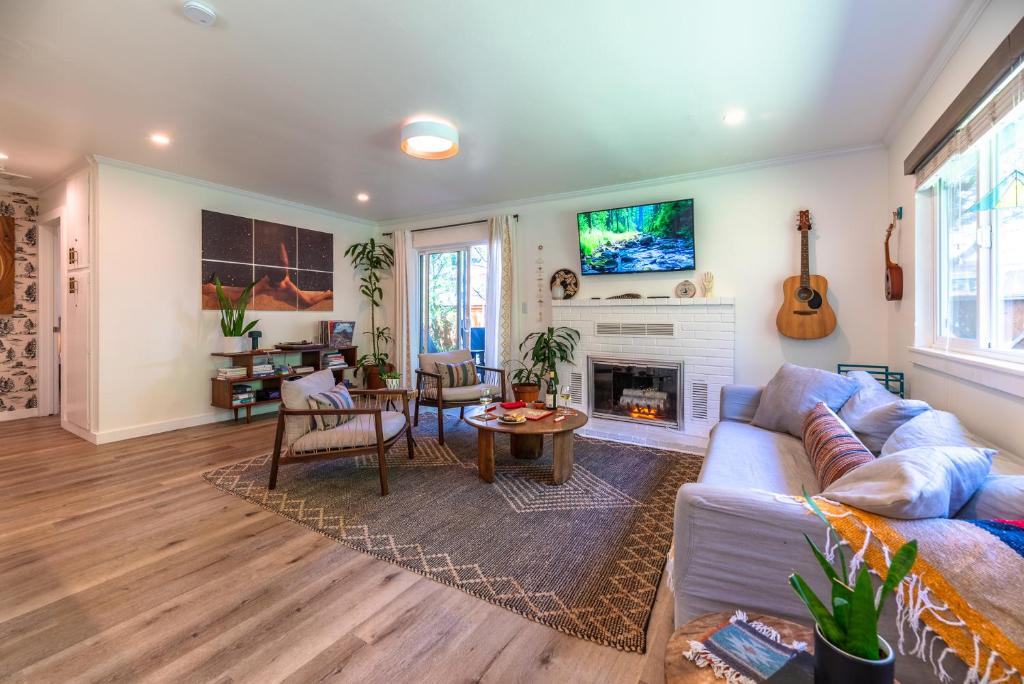 a living room with a couch and a fireplace at Russian River Bungalow in Guerneville