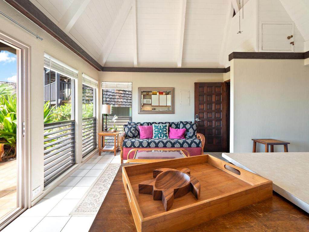 a living room with a couch and a coffee table at #04 Black Sand Beach Condo in Pahala