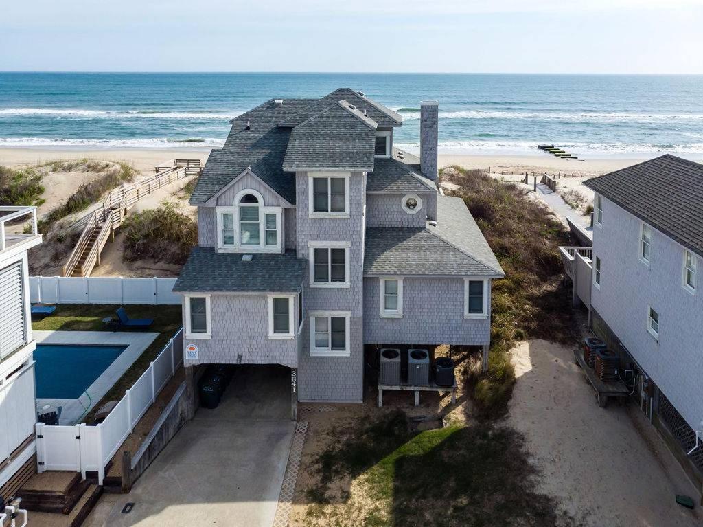 an aerial view of a house next to the beach at Looking Glass - Nags Head MP 12, Oceanfront, Ocean View, Pool, Hot Tub, Pets OK, Flex Stays in Nags Head