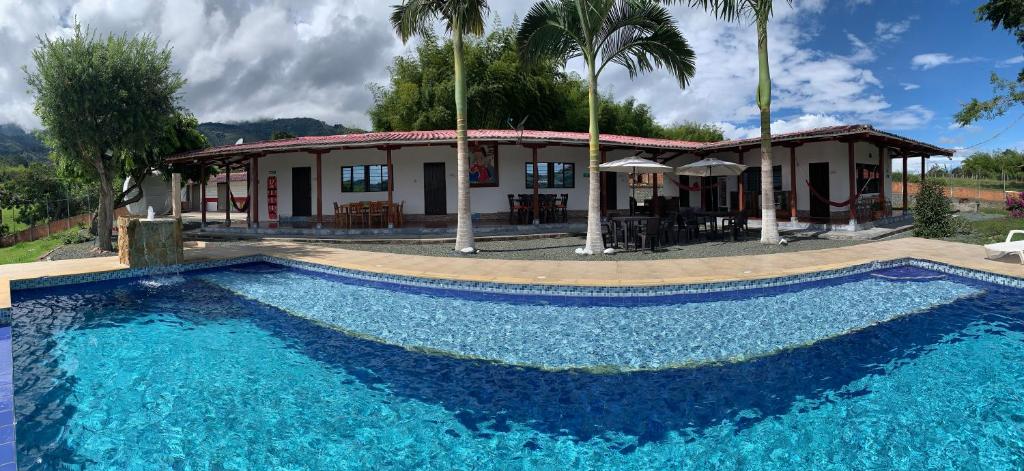 a large swimming pool in front of a house at Finca Hotel San Sebastian in La Paloma