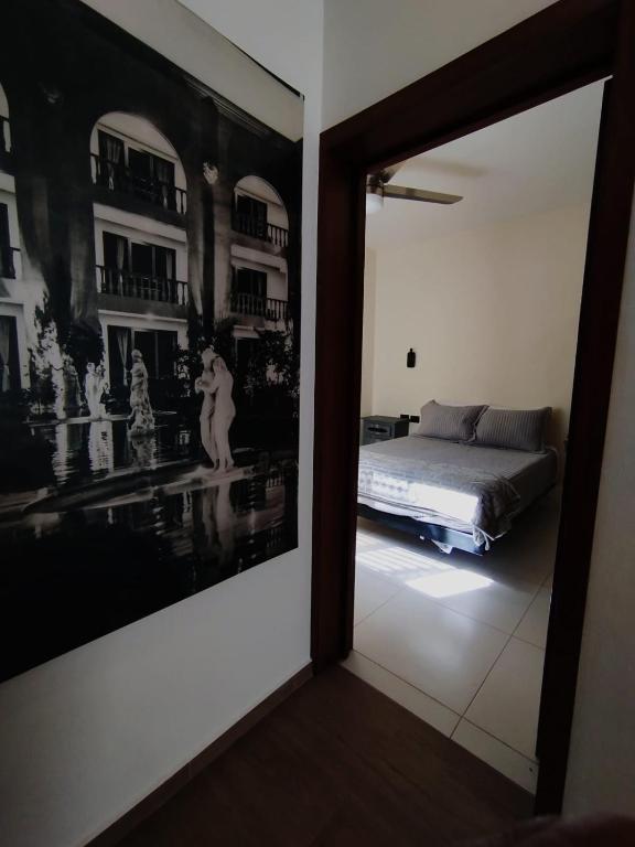 a bedroom with a bed and a large picture on the wall at Día y noche in Guadalajara