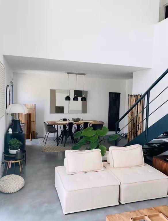 a living room with two white couches and a table at La parenthèse basque in BIQ