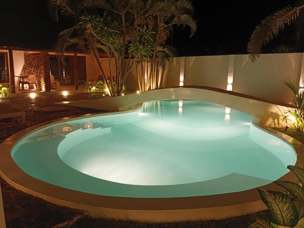 a swimming pool at night in a resort at ZENARA lombok - Boutique Adults Only in Kuta Lombok