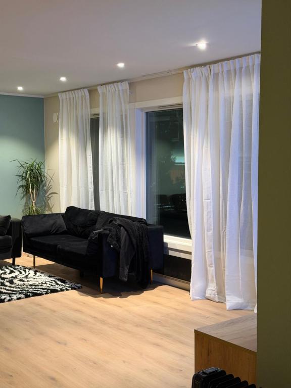 a living room with a couch and a window at Gardermoen Airport, 5Min in Sand