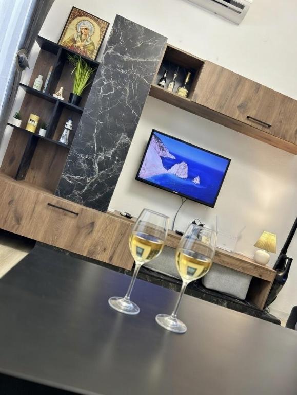 two glasses of white wine sitting on a table at Kjara's Nest in Neoi Epivates