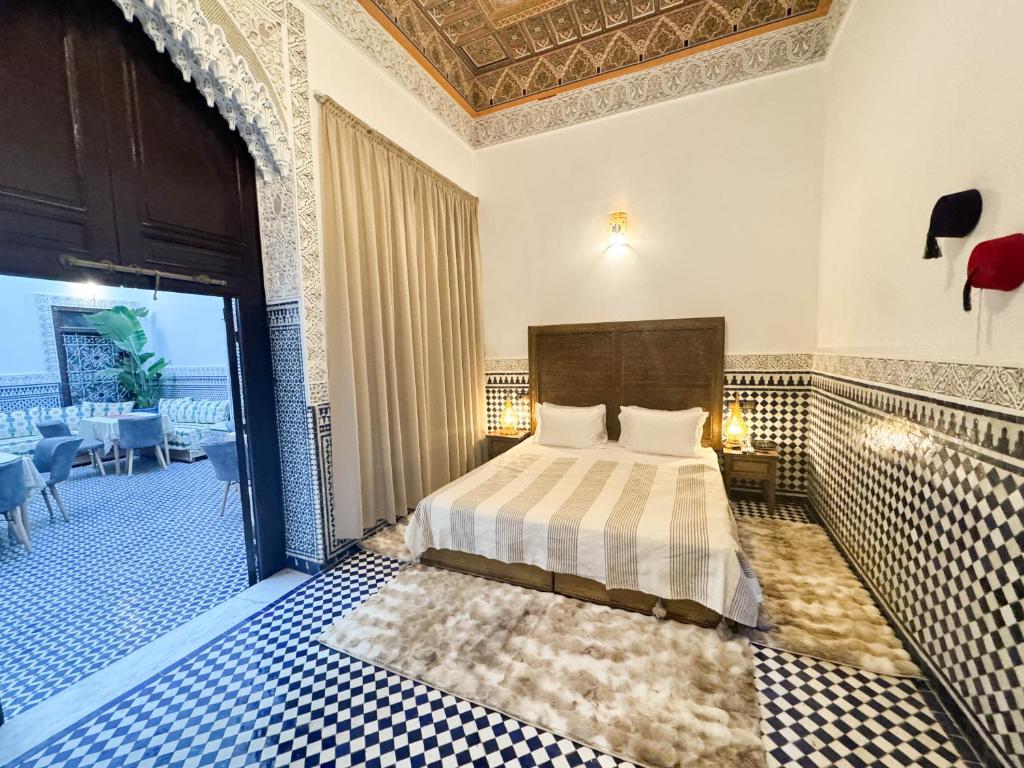 a hotel room with a bed and a balcony at Riad Azul Fes & SPA in Fez