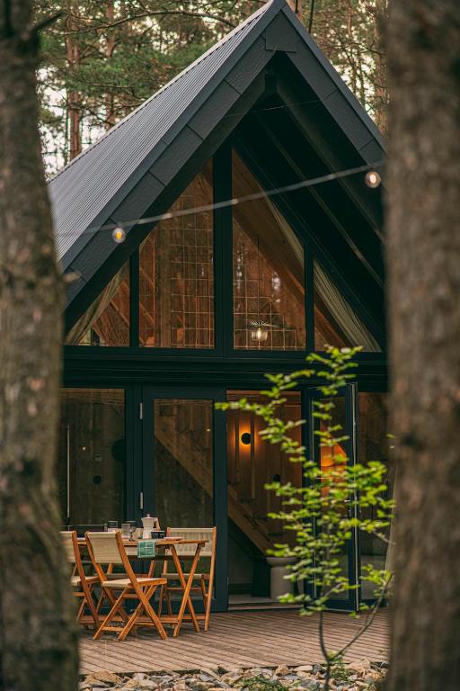 a house with a table in front of it at Leśny Chill House in Grodziec