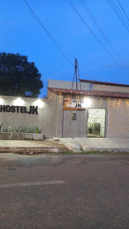 a building with a sign on the side of it at Hostel JK in Bom Jesus