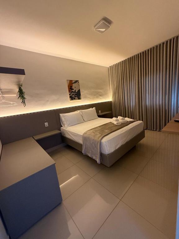 a bedroom with a bed and a bench in it at Apto Mais Decor in Salinas