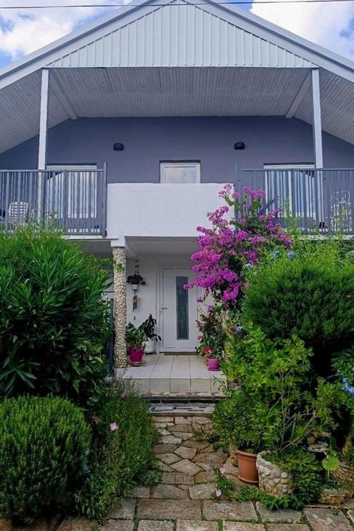 a blue house with a porch and some plants at Apartments with parking space Vodice - 927 in Vodice