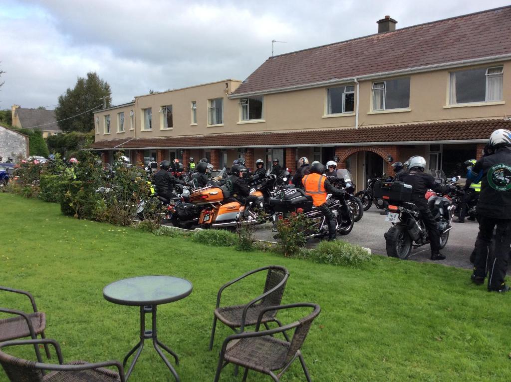 a group of people on motorcycles parked in a yard at The Gardens guest accommodation in Killarney